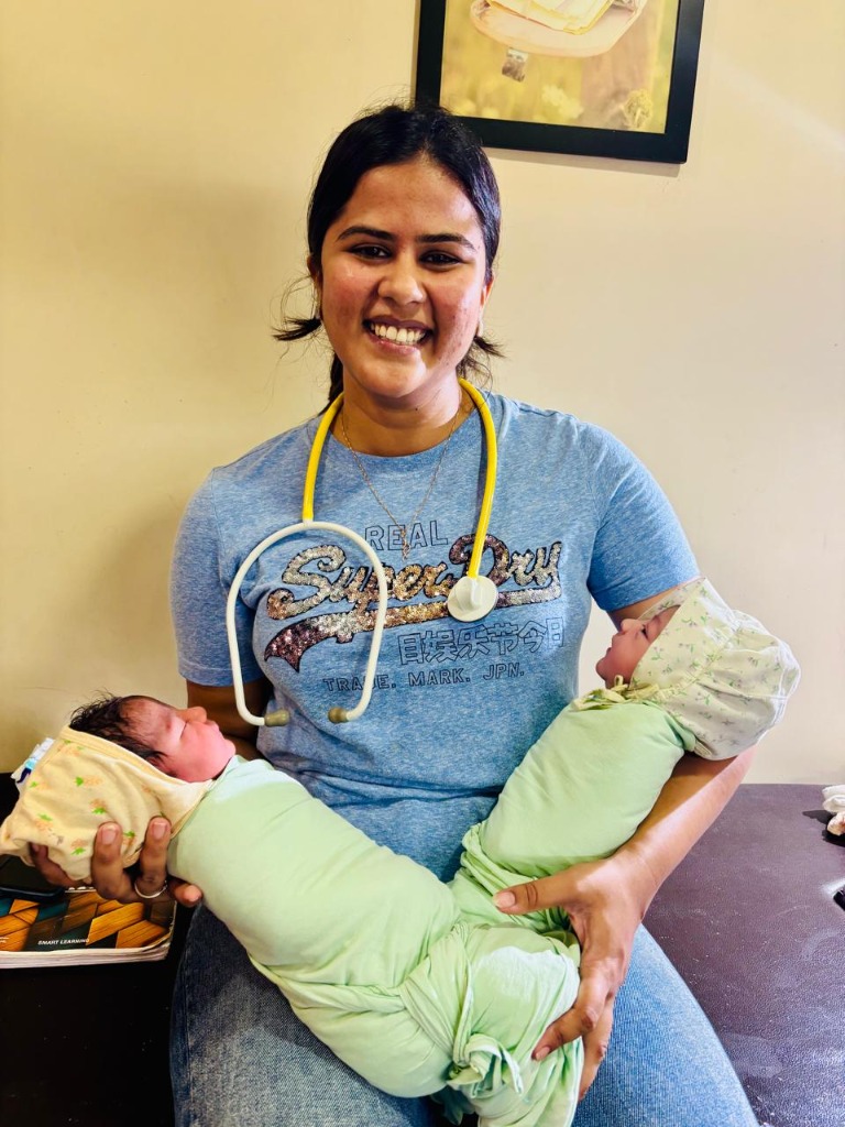 Dr. Aastha Jain smiling in clinical consultation room