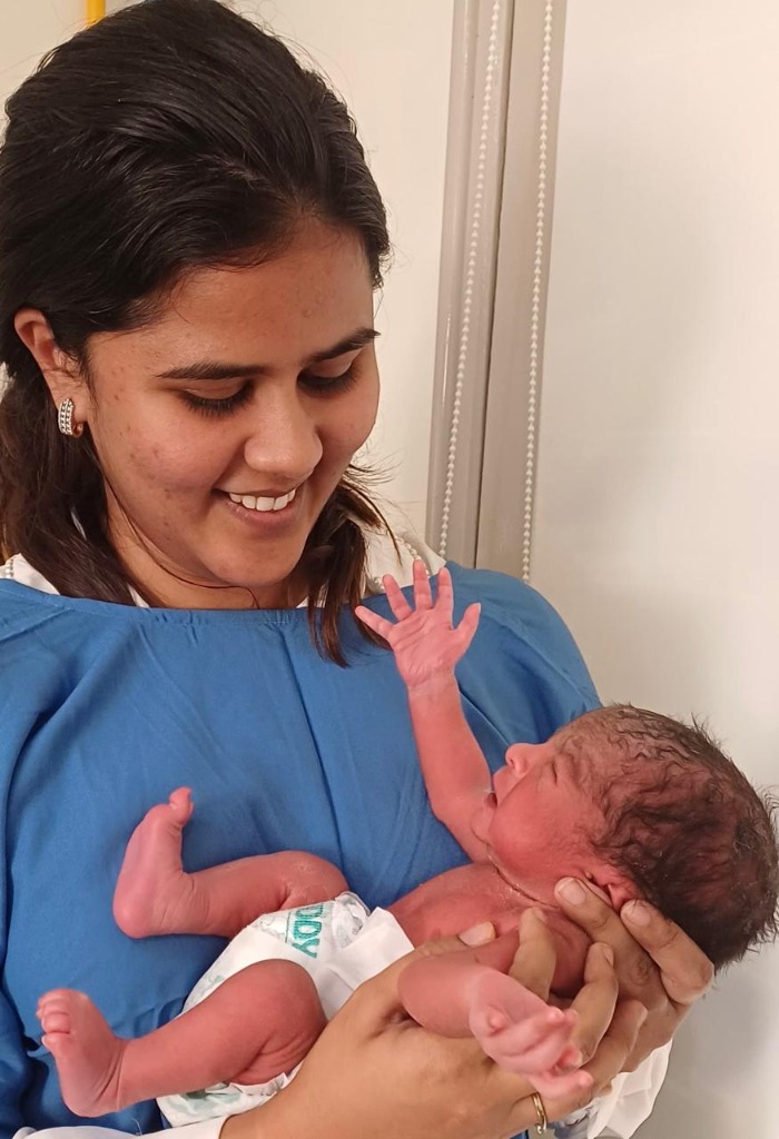 Dr. Aastha Jain checking child reflex points in a clinical setting